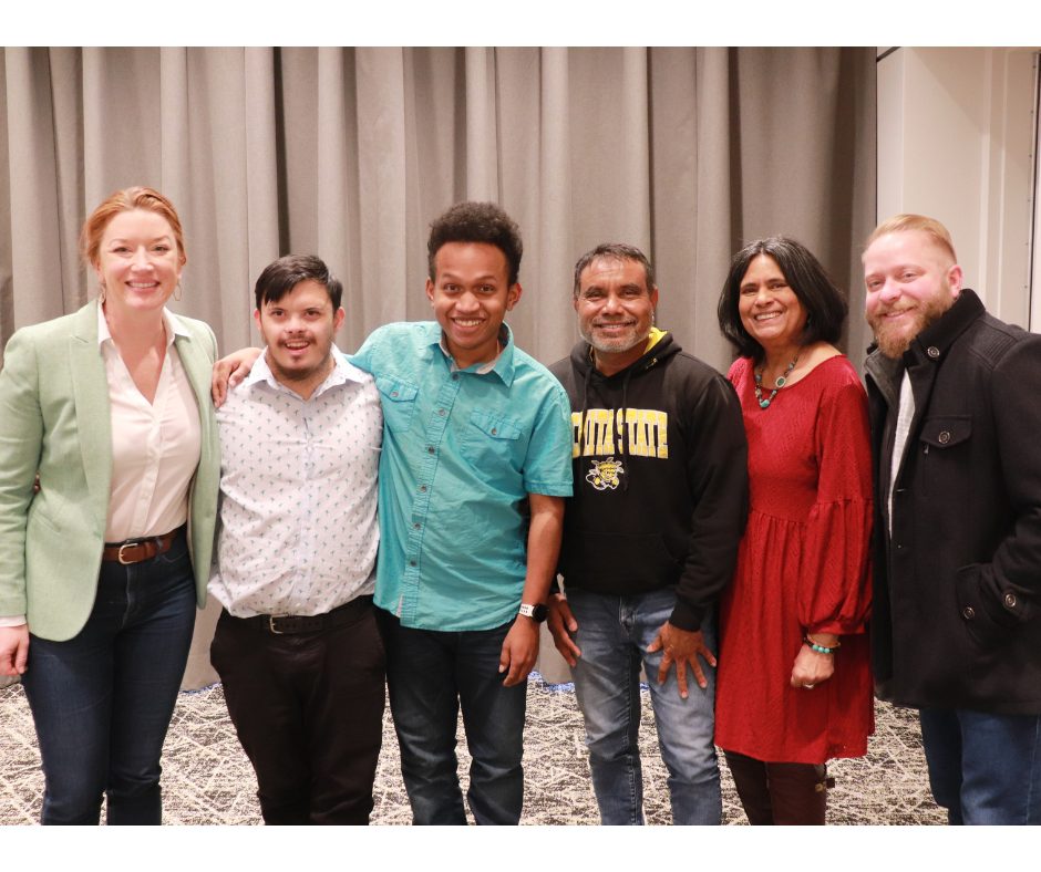 A group photo of Tavrick with his family and friends celebrating his win.